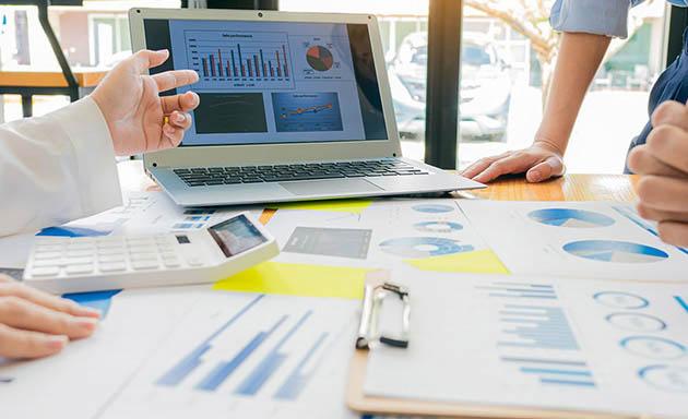 people looking at a flowchart on a laptop