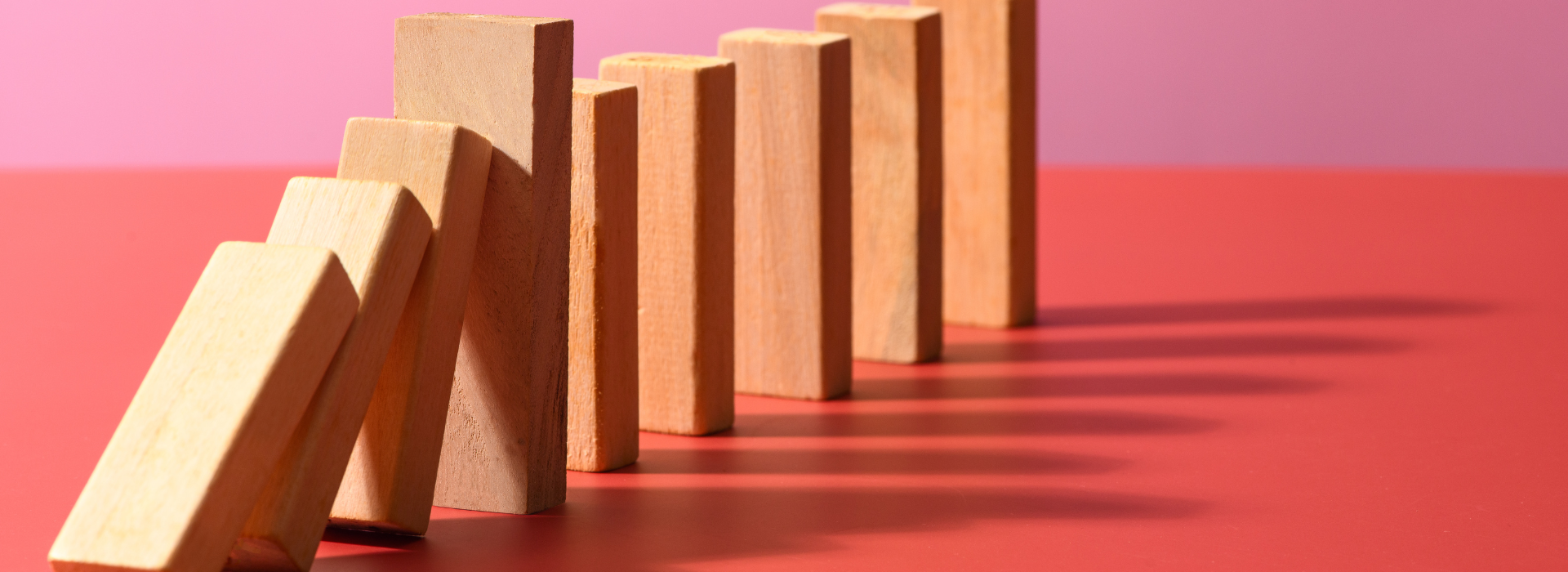 Wooden blocks against a pink background