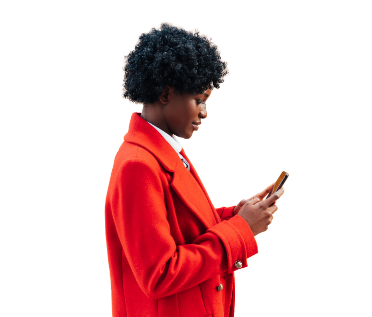 Person with dark curly hair wearing bright red blazer holding smartphone, side profile view against white background.