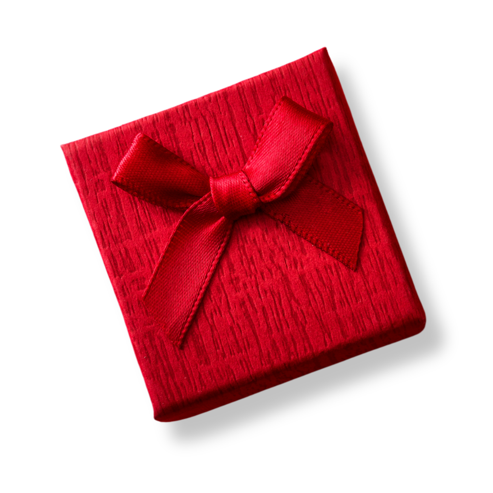 Red gift box with textured surface and red ribbon bow on white background, viewed from above at an angle.