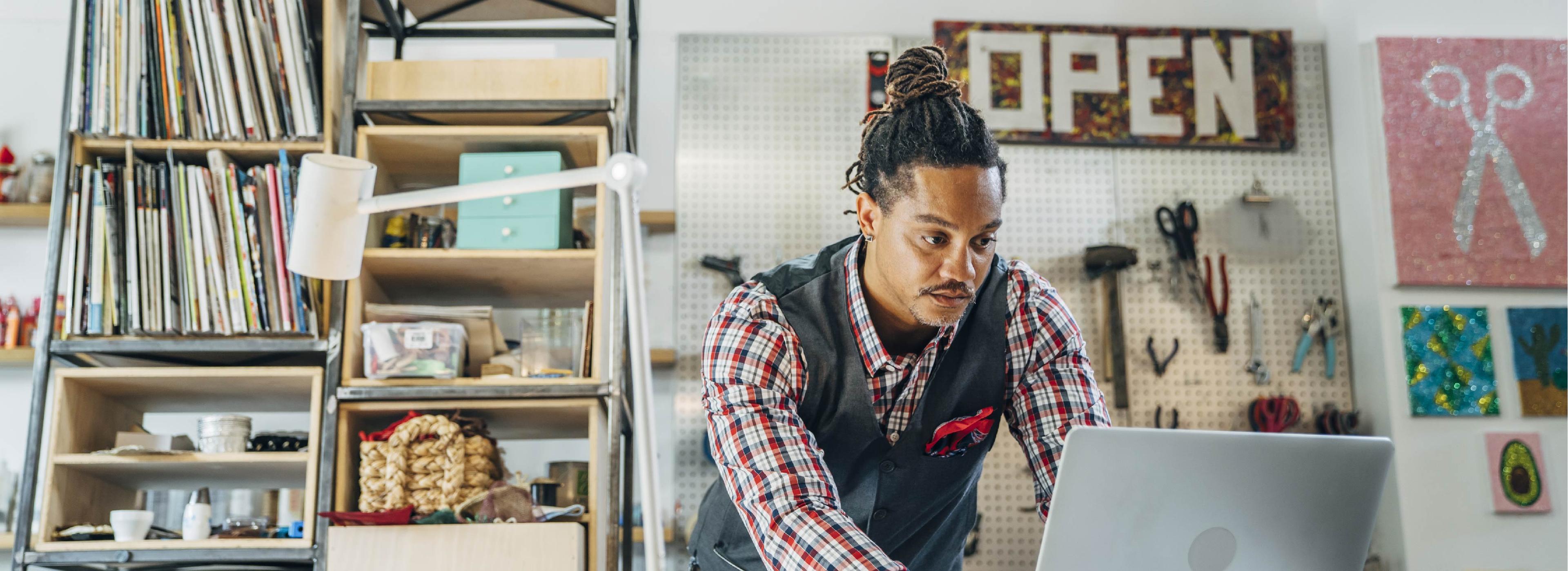 man using a laptop inside a store or office environment