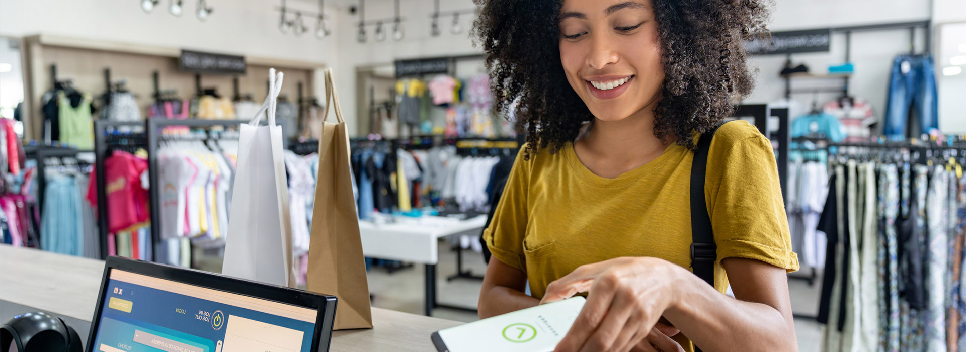 A woman paying in store on mobile